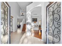 Two-story entryway with an open staircase and hardwood floors at 18127 Sandy Pointe Dr, Tampa, FL 33647
