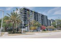 Exterior view of a multi-story building with palm trees and landscaping at 201 W Laurel St # 503, Tampa, FL 33602