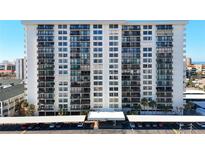 Front view of a tall, white residential building with parking at 400 Island Way # 1411, Clearwater Beach, FL 33767
