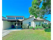 Charming single Gathering home featuring a well-manicured lawn and a covered carport at 9107 Lingrove Rd, Weeki Wachee, FL 34613