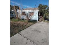 Light blue house with a small yard and driveway at 13149 4Th E St, Madeira Beach, FL 33708