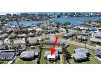 Aerial view showing a single-story home near the water at 14140 E Parsley Dr, Madeira Beach, FL 33708