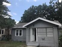 Gray brick house with open door, two windows, and small front yard at 2360 25Th S Ave, St Petersburg, FL 33712