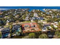Stunning aerial view of waterfront property with city skyline and lush greenery at 2618 S Dundee St, Tampa, FL 33629