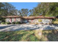 Brick ranch home with mature landscaping and a large driveway at 4609 Horton Rd, Plant City, FL 33567