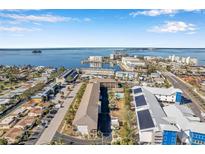 Aerial view of waterfront property showing building, pool, and surrounding area at 460 Paula S Dr # 101, Dunedin, FL 34698