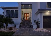 Inviting front entrance featuring a vibrant door, decorative wreaths, and comfortable seating area at 5951 Bay Dr, Gulfport, FL 33707