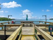 Community dock with seating and waterfront views at 1515 Pinellas Bayway S # 40, St Petersburg, FL 33715