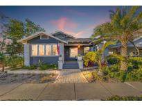 Charming bungalow with gray siding, landscaped yard, and a welcoming front porch at 2235 Dartmouth N Ave, St Petersburg, FL 33713