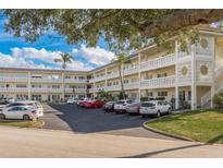 Condo building with ample parking and lush landscaping at 2451 Canadian Way # 47, Clearwater, FL 33763