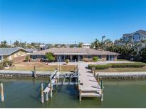 Bird's eye view of waterfront home with private dock and pool at 15 Marina Ter, Treasure Island, FL 33706