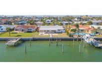 Aerial view of waterfront home with private dock and boat slip at 11775 6Th E St, Treasure Island, FL 33706