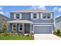 Charming two-story home with a two-car garage, landscaped yard, and a covered front porch at 16025 7Th E Ave, Bradenton, FL 34212