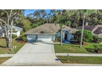 Attractive home with three-car garage, situated on a tree-lined street at 4953 Edgewater Ln, Oldsmar, FL 34677