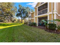 Ground level condo with a screened patio and grassy backyard at 9481 Highland Oak Dr # 512, Tampa, FL 33647