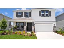 Charming two-story home with a well-manicured lawn and stylish stone accents on the front porch at 16017 7Th E Ave, Bradenton, FL 34212