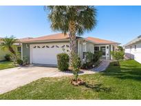 Single-story home with attached garage and well-maintained landscaping at 3954 Marine Pkwy, New Port Richey, FL 34652