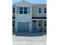 Charming townhome with a one-car garage and neutral gray paint scheme at 4588 Pleasant Ave, Palm Harbor, FL 34683