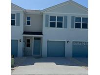 Charming townhouse with blue shutters and attached one-car garage at 4596 Pleasant Ave, Palm Harbor, FL 34683