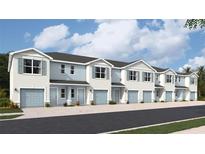 New townhouses with light blue garage doors and white exterior at 4604 Stargazer Ct, Palm Harbor, FL 34683