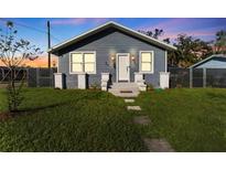 Charming craftsman style home with gray siding, white trim, and a well-manicured lawn at 702 E Gilchrist St, Plant City, FL 33563