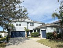 Two-story house with a two-car garage and basketball hoop at 10836 Carloway Hills Dr, Wimauma, FL 33598