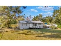 Single story home with a metal roof and spacious yard at 11845 Carmen Ave, Dade City, FL 33525