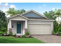 One-story home with teal door, light gray siding, and a two-car garage at 12158 Meditation Trl, Venice, FL 34293