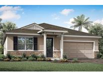 Single-story home with a two-car garage, stone accents, and a landscaped lawn at 17909 Meditation Trl, Venice, FL 34293