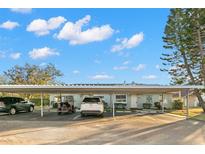Charming light blue home with a carport and designated parking spaces at 2232 Greenwich Dr # 56, Sun City Center, FL 33573