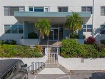 Condo building exterior featuring a modern design and lush landscaping at 55 Harbor View Ln # 301, Belleair Bluffs, FL 33770