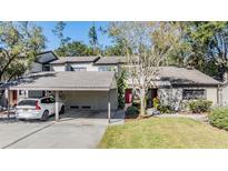 Townhouse with carport, landscaping, and a tranquil setting at 215 Woods Landing Trl, Oldsmar, FL 34677