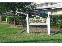 Winston Park NE Condominiums sign in front of building and parking lot at 4915 Bay Ne St # 123, St Petersburg, FL 33703