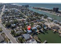 Waterfront property with easy access to the Gulf, a private dock, and a stunning aerial view of the neighborhood at 505 80Th Ave, St Pete Beach, FL 33706