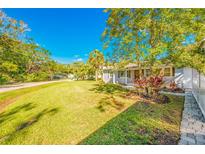 Charming house with a spacious front yard, well-manicured lawn, and walkway at 6210 Sanders Dr, Tampa, FL 33611