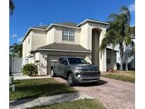 Two-story home with a two-car garage and a paved driveway at 1449 Kaffir Lily Ct, Trinity, FL 34655