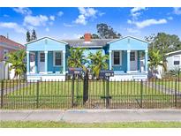 Front view of two charming light blue houses with a well-manicured lawn at 2483 13Th N Ave, St Petersburg, FL 33713