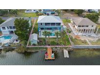 Elevated home with private dock, pool, and lush landscaping at 3270 Hibiscus Dr, Hernando Beach, FL 34607