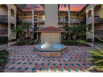 Community courtyard with fountain and Spanish tile at 2400 Feather Sound Dr # 128, Clearwater, FL 33762