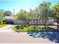 Charming light green house with a spacious front yard and mature trees at 5626 28Th S Ave, Gulfport, FL 33707