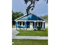Charming blue house with a white trim, front yard, and driveway at 4202 N 15Th St, Tampa, FL 33610