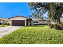 Charming ranch home with a well-manicured lawn and mature trees at 5857 25Th S St, St Petersburg, FL 33712
