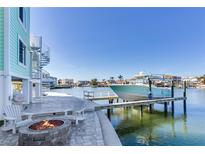 Boat dock with fire pit and seating area, offering waterfront living at 17410 1St E St, Redington Shores, FL 33708