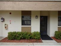 Building exterior showcasing a well-maintained entrance with landscaping at 2700 Nebraska Ave # 4-101, Palm Harbor, FL 34684