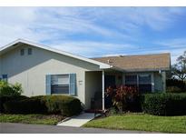 Well-maintained ranch home with landscaped lawn and blue shutters at 409 Bloom Ct # 2B, Sun City Center, FL 33573