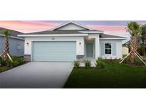 Charming one-story home with light gray garage door and landscaping at 475 Winwood Ct, Port Charlotte, FL 33954