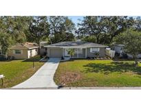Newly renovated home with a well-manicured lawn and driveway at 2085 Georgianna St, Largo, FL 33774