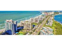 Aerial view of beachfront condo building with ocean and city views at 1480 Gulf Blvd # 1107, Clearwater Beach, FL 33767