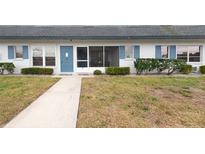 Charming condo with blue accents, screen door, and manicured landscaping offers a welcoming exterior at 4444 Swift Rd # 20, Sarasota, FL 34231