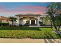 Single-story home with inviting front porch and well-manicured lawn at 4930 Cedar Oak Way, Sarasota, FL 34233